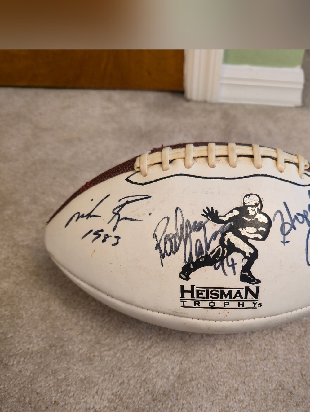 Collectible football commemorating Heisman Trophy winners, featuring multiple